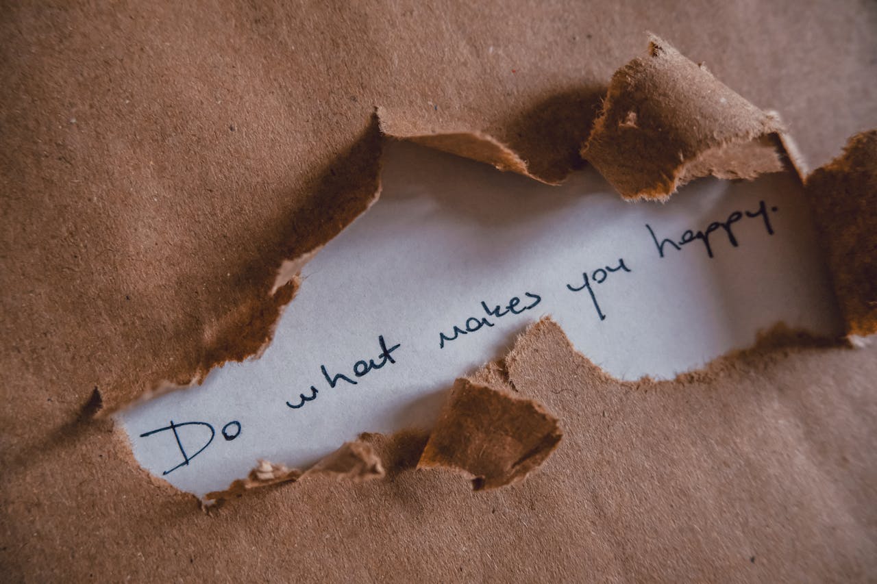 Brown paper revealing message 'Do what makes you happy.'