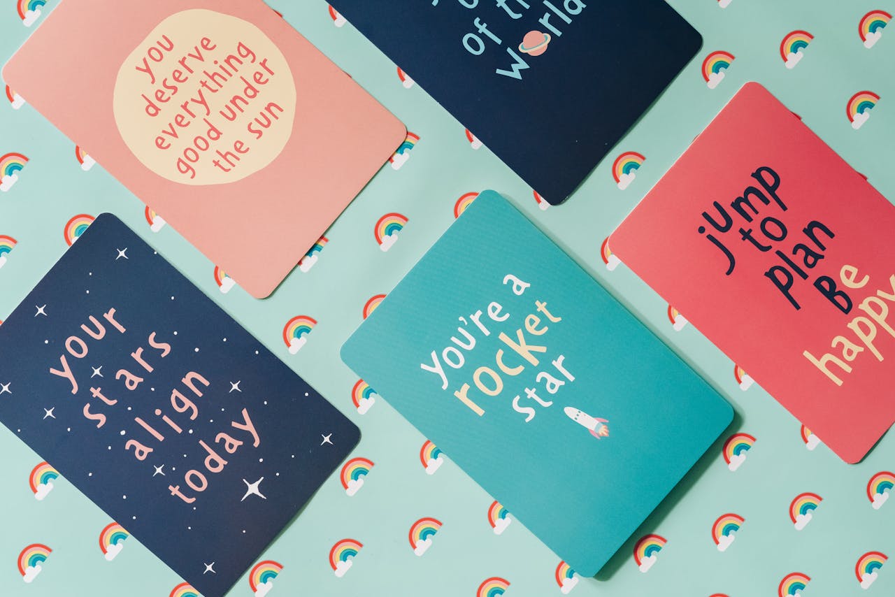 Colorful motivational cards with uplifting messages on a rainbow-themed backdrop.